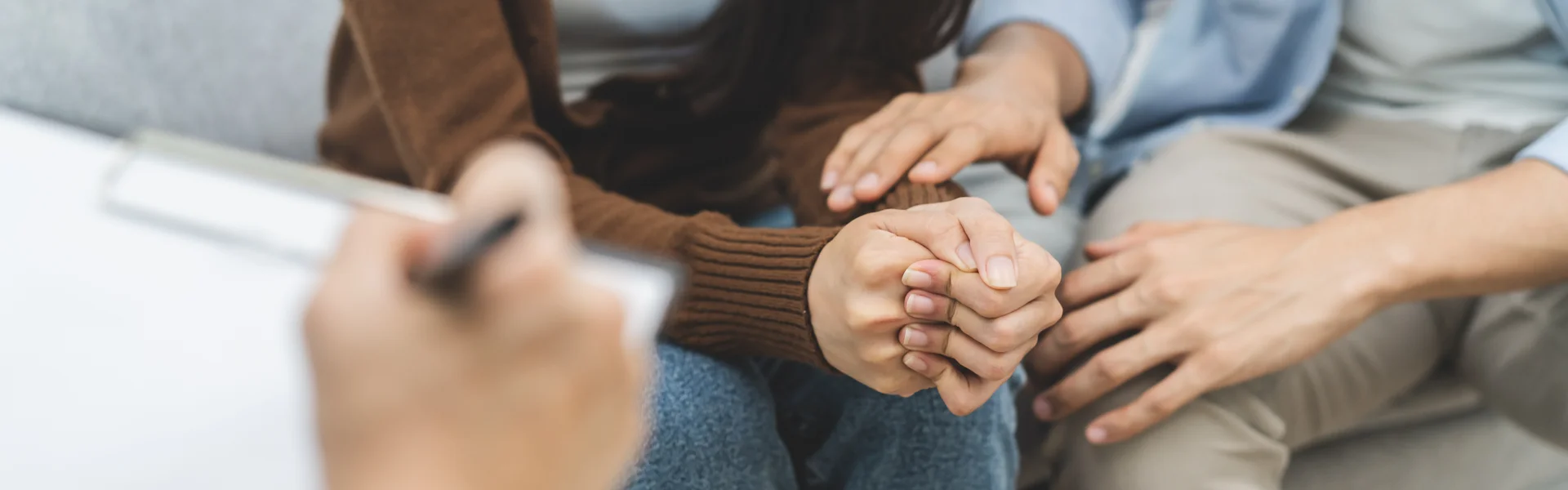 Couples holding hands during trauma-focused therapy session, emphasizing emotional support and connection in Sacramento.
